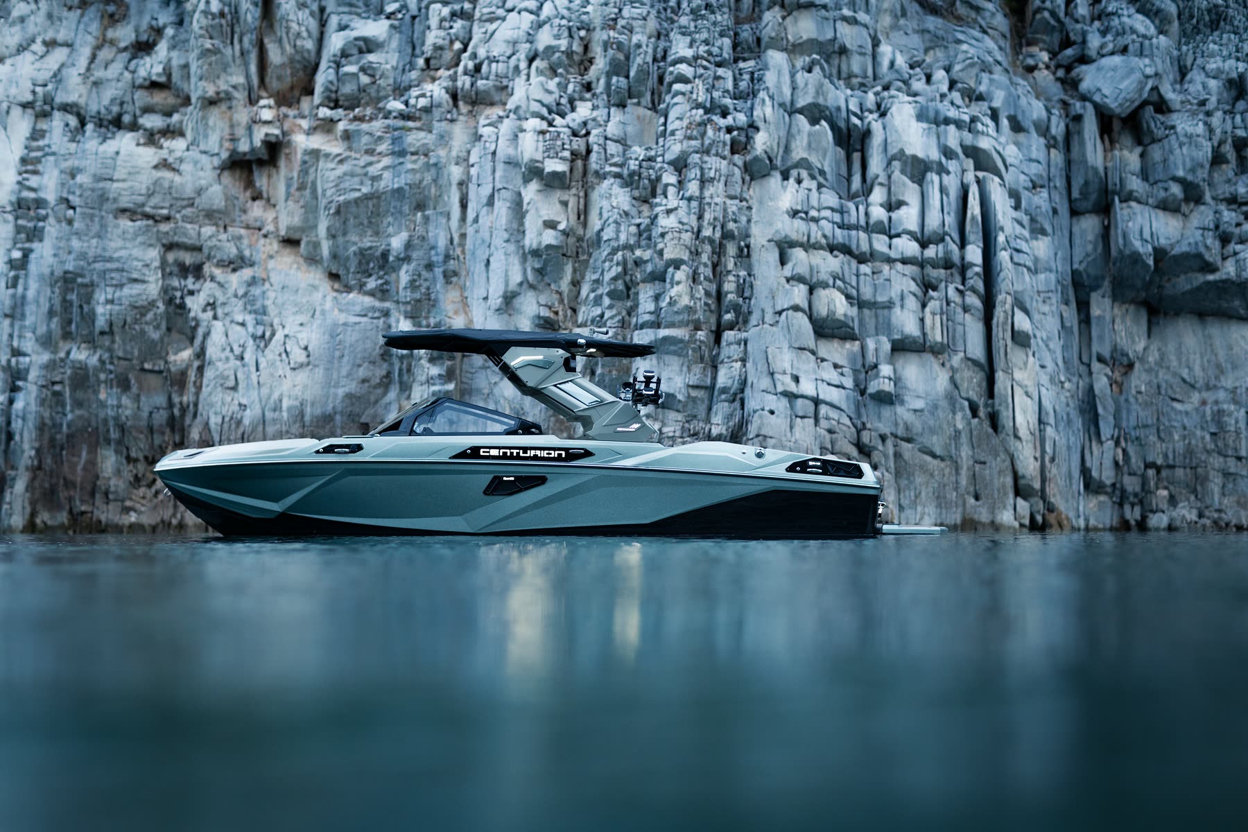 Custom gelcoat on a Centurion RS beside a stone cliff