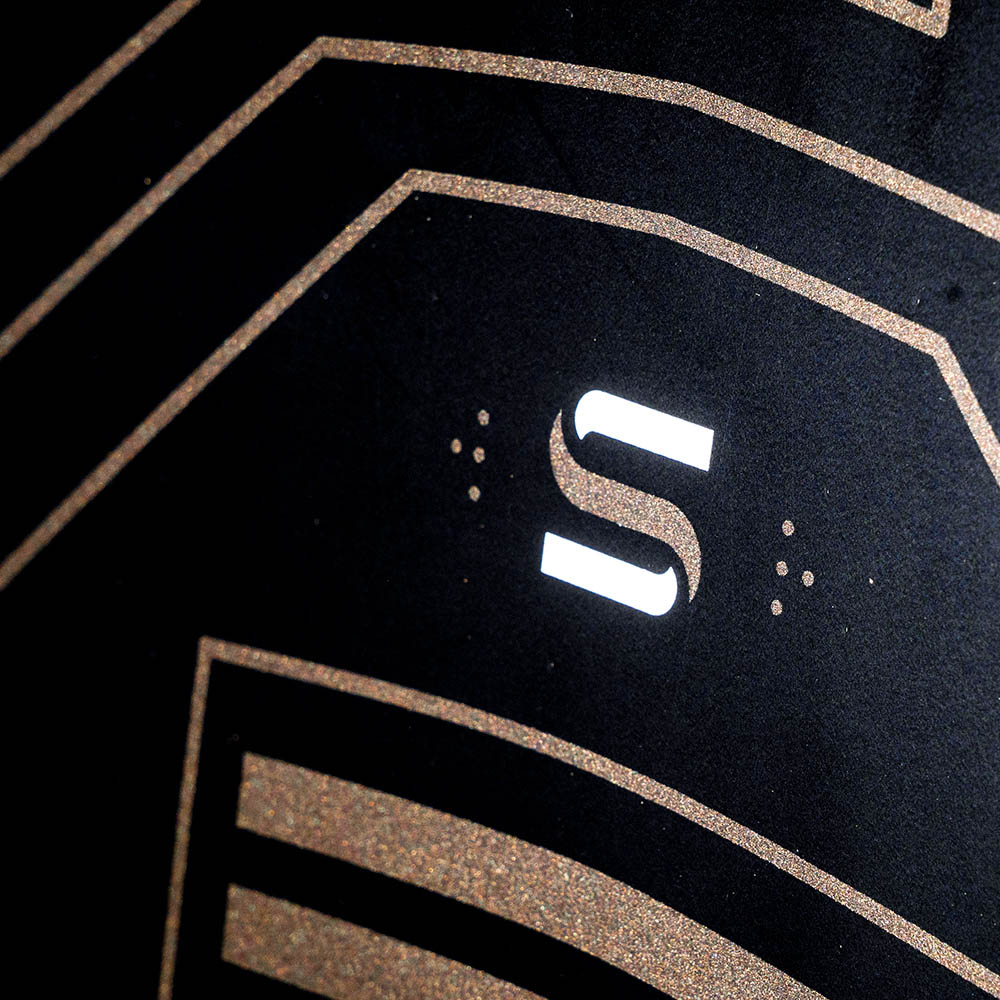 Hyperlite Starship Wake Foil Board 2027, gold circuit lines and white striped emblem on the black underside
