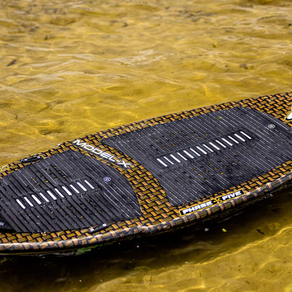 Phase 5 Model X LTD Wakesurf Board 2027 – deck resting on the water
