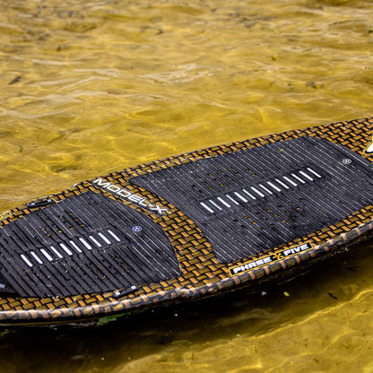 Phase 5 Model X LTD Wakesurf Board 2027 – deck resting on the water