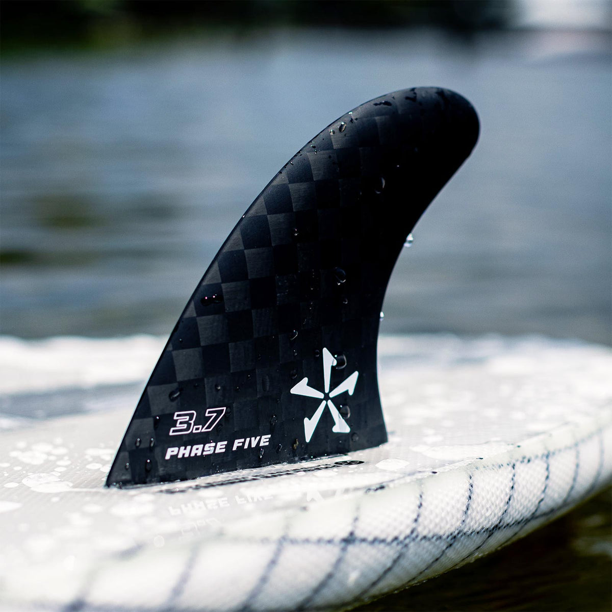 Phase 5 Carbon Twin Surf Fin Set for FCS, 3.7-inch fin mounted on a board