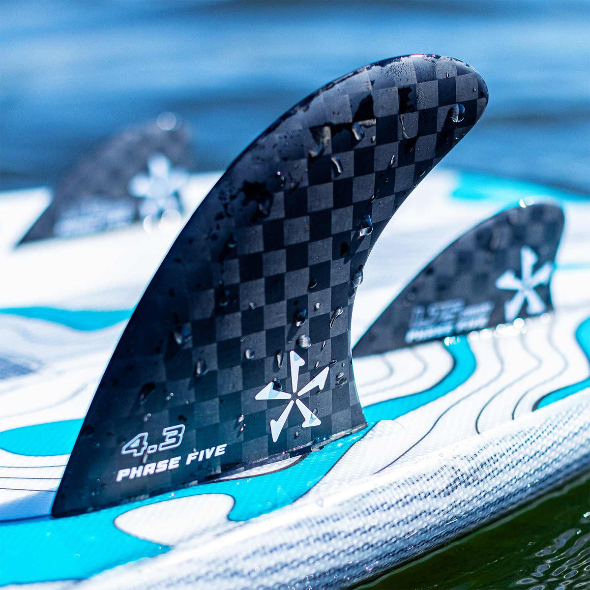 Phase 5 Carbon Twin Surf Fin Set for FCS, 4.3-inch fin mounted on a board