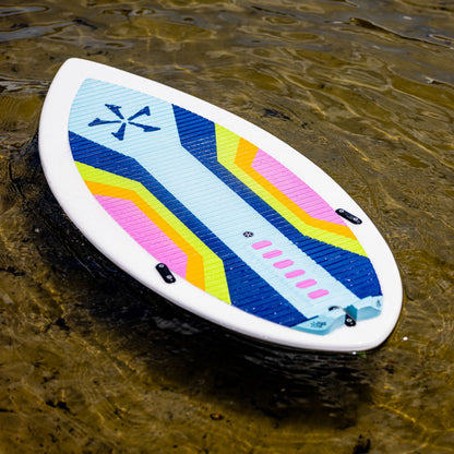 Phase 5 Scamp CL Wakesurf Board 2027 – complete striped traction deck resting on shallow water